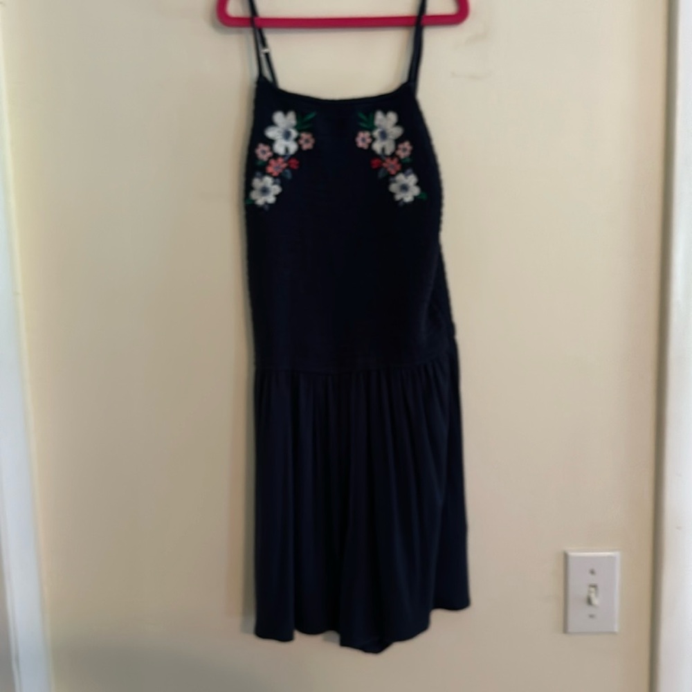 Navy blue romper, Hollister size S, has a floral design at the top